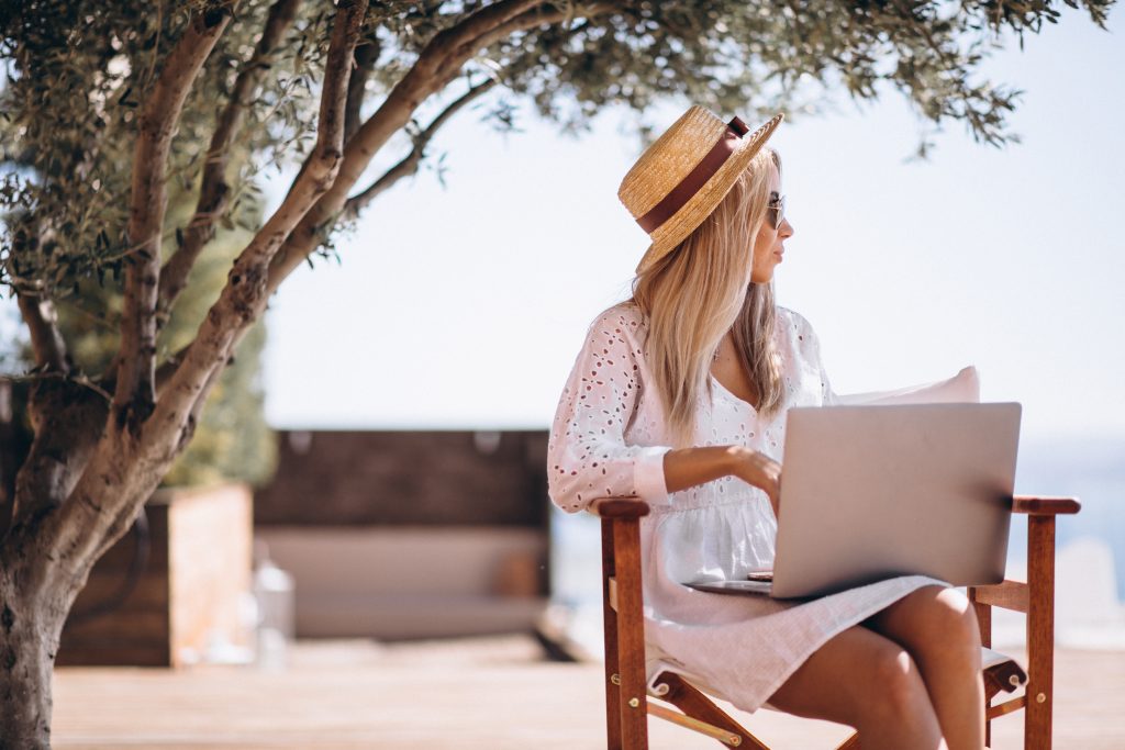 A woman working on laptop outdoors
