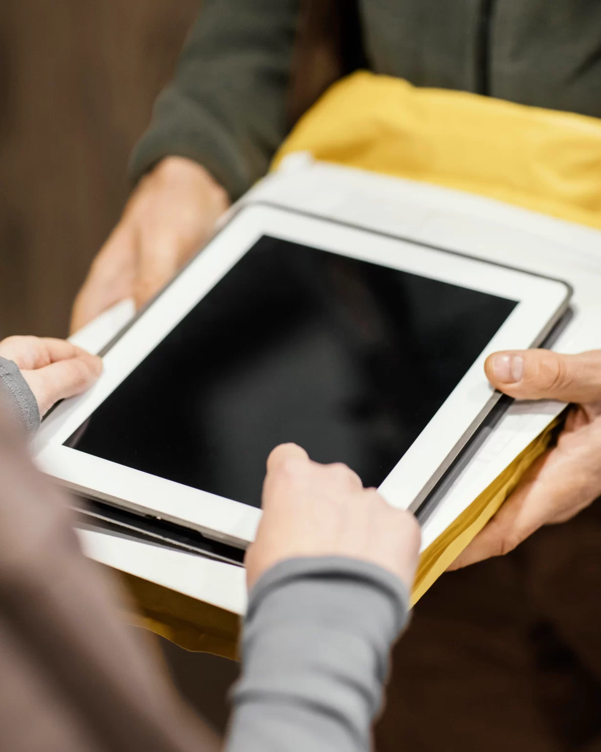 close up of tablet with a woman placing electronic signature after delivery